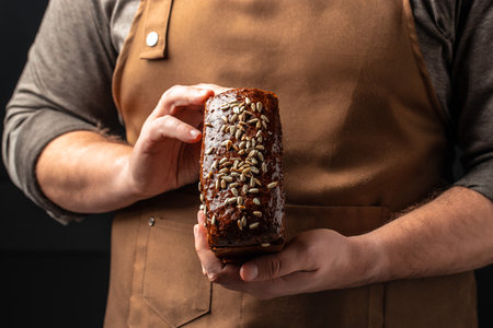 Wheat square bread in hands, domestic cozy bakery pastry. Healthy food concept. place for text,