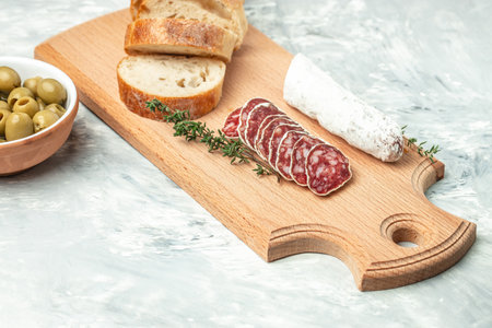 Traditional Spanish Fuet dried sausage on a light background. banner, menu, recipe place for text,...