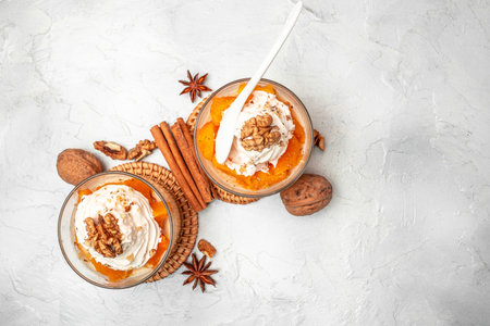 Pumpkin parfait with whipped cream, nuts in glass. Delicious breakfast or snack.の写真素材
