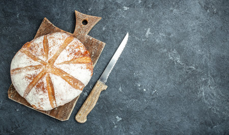 Homemade sourdough bread in hand. Healthy food concept. place for text, top view.