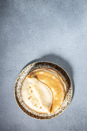 Crepes on plate. Homemade thin fresh crepes for breakfast or dessert. vertical image. place for text.の写真素材