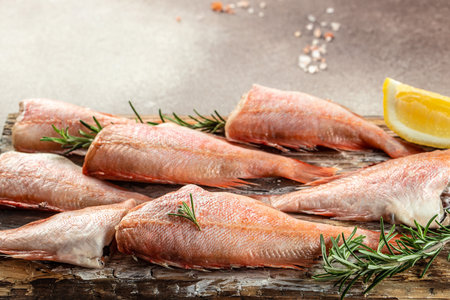 fish, red snapper with lemon, rosemary, salt on a light background. Healthy food concept. place for text, top view.の写真素材