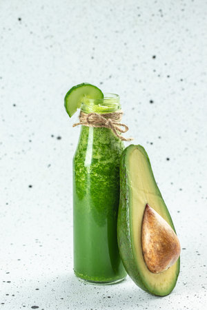 Detox green smoothie in a bottle on a light background, vertical image. place for text,の写真素材