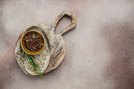 Empty wooden board with herbs and spices on black kitchen table. culinary background, top view.の写真素材