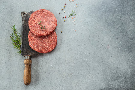 Raw veal mince Burger steak cutlets on a light background, Restaurant menu, dieting, cookbook recipe top view.の写真素材