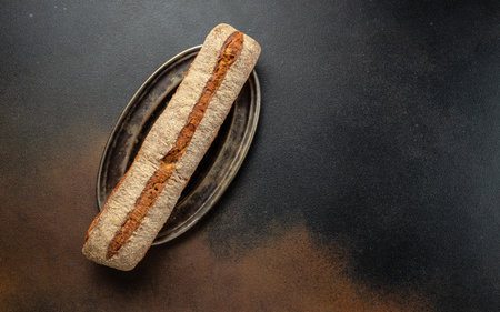 fresh dark buckwheat bread baguette. banner, menu, recipe place for text, top view.