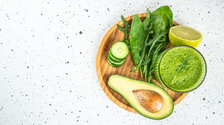 Green vegetable smoothie on a light background. Long banner format. top view.