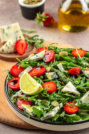 strawberry salad with asparagus, arugula, blue cheese and seeds. Delicious breakfast or snack, Clean eating, dieting, vegan food concept. top view.の写真素材