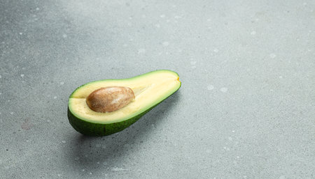 Avocado halves slices. Vegetarian food concept. banner, menu, recipe place for text, top view.の写真素材