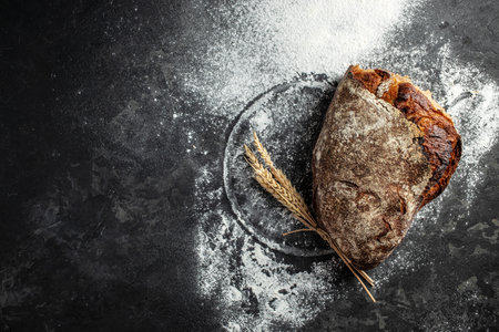 Fresh homemade crispy bread on a dark background. banner, menu, recipe place for text, top view.