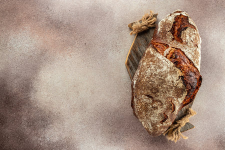 bread on a wooden board. banner, menu, recipe place for text, top view.の写真素材