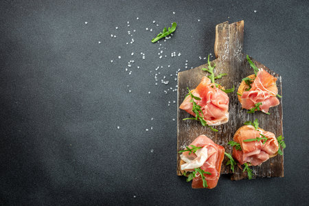 Open sandwich set with cream cheese, prosciutto on a wooden board. banner, menu, recipe place for text, top view.の写真素材