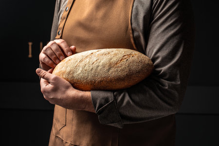 bran bread in men's hands, Healthy food concept. place for text,の写真素材