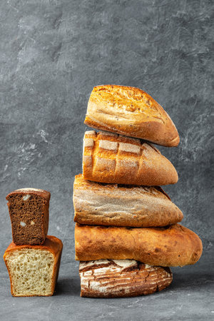 Homemade fresh baked various loafs of wheat and rye bread. vertical image. place for text,の写真素材