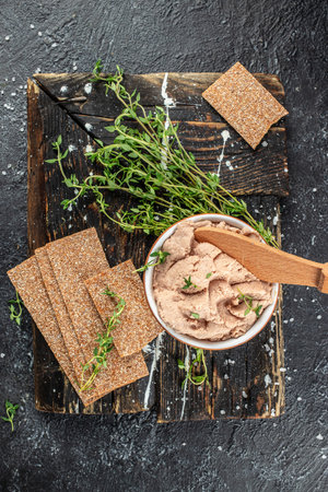 Fresh homemade chicken liver pate on a wooden board. vertical image. top view. place for text.の写真素材