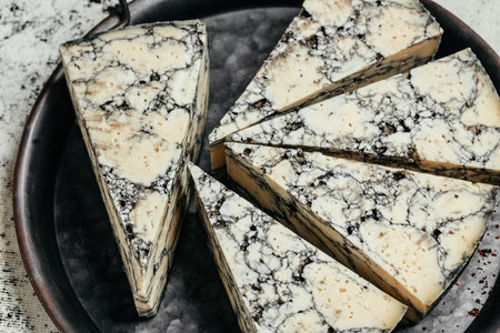 Asiago italian cheese with cuttlefish ink on a wooden board. banner, menu, recipe place for text, top view.の写真素材