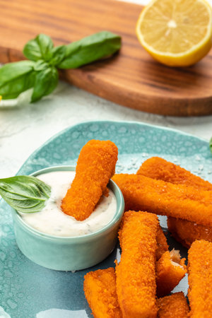 fish sticks, fish fillet fingers breaded served with tartar sauce, vertical image. top view. place for text,の写真素材