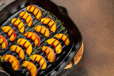 Gourmet Roasted Peaches in pan. banner, menu, recipe place for text, top view.の写真素材