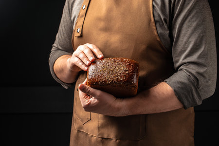Wheat square bread in hands, domestic cozy bakery pastry. Healthy food concept. place for text,