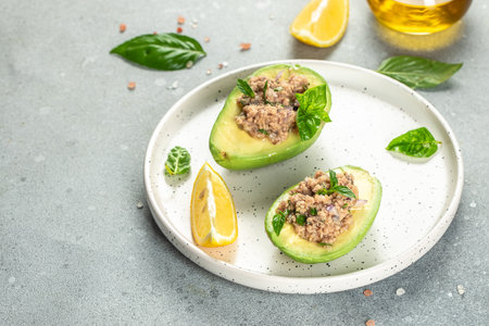 Salad of avocado and tuna on a light background top view. place for text,