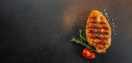 Tasty Grilled chicken fillet, Delicious breakfast or snack, Clean eating, dieting on a dark background. top view. place for text.の写真素材
