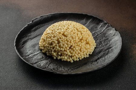 Pasta Ptitim with basil leaves on a dark background. top view. copy space for text,の写真素材