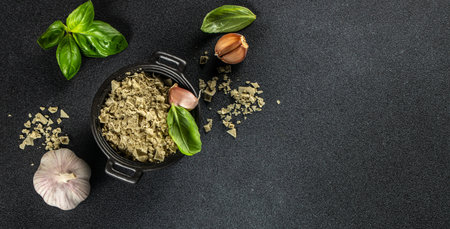 Basil salt is a natural spice with sea salt and fresh basil as seasoning on a dark background, Long banner format. top view. copy space for text,の写真素材