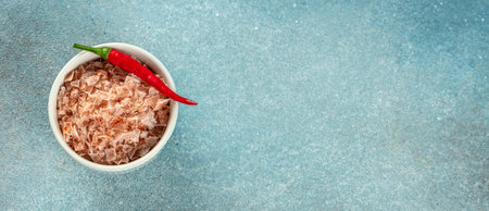 paprika salt, sea salt, pepper in bowl on a blue background. Long banner format. top view. copy space for text.の写真素材