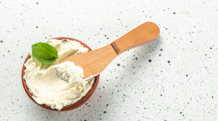 cream cheese in bowl on a light background. Long banner format. top view.