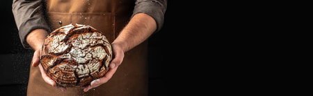 Homemade rye bread in hands. Healthy, clean eating. Healthy food concept. Long banner format. copy space for text.の写真素材