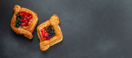 Puff pastry with strawberries, blueberries. Long banner format. top view. copy space for text,の写真素材