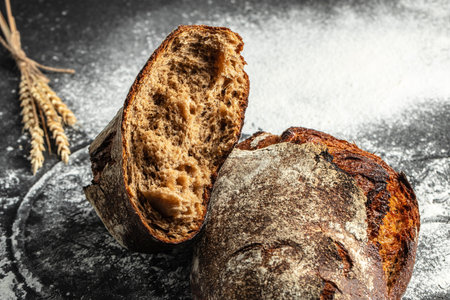 Fresh bread on table. healthy eating and traditional bakery on a dark background. banner, menu, recipe place for text, top view.の写真素材