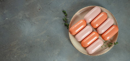 boiled meat pork sausages on plate. Long banner format. top view. copy space for text.の写真素材