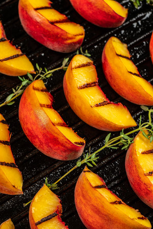 Grilled peach with honey on aa grill pan. Food recipe background. Close up.の写真素材