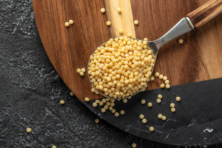 Raw pasta fregola sarda ricette on a dark background. top view. copy space for text,の写真素材