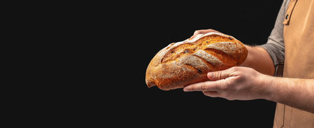 Baker man holding bread. loaf rye wheat bread. Long banner format. copy space for text.