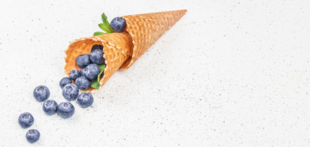 Berries in waffle cones, Fresh fruit blueberry ice cream on a light background, top view. copy space,の写真素材