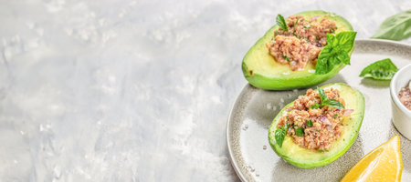 Avocado stuffed with tuna. Long banner format. top view. copy space.の写真素材