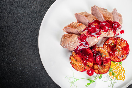 Baked duck fillet with plums and cranberry sauce, Thanksgiving dinner, cookbook recipe top view,の写真素材