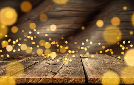 festive holiday background with gold bokeh lights. blurred wooden background with Christmas lights, copy space.の写真素材