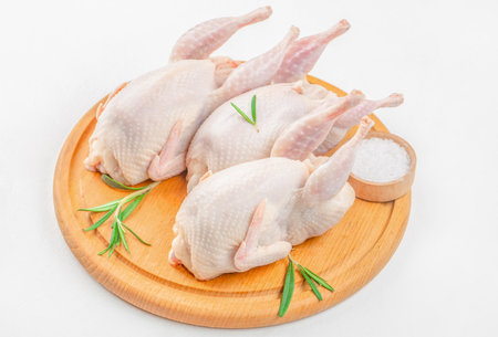 Young quails meat on white table on a wooden board, copy space.の写真素材