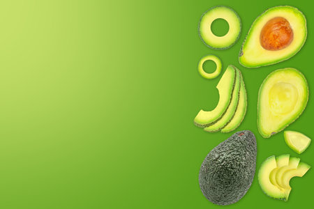 Ripe fresh avocado on green background. Haas variety avocado isolated, copy space.