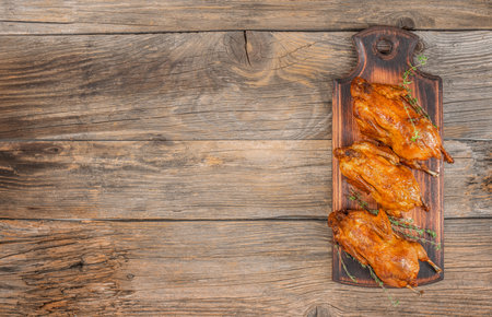 Baked quail with herbs. Flat lay. Top view. Free copy space.の写真素材