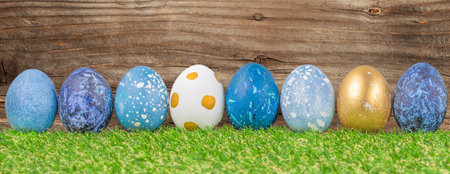 Easter holiday concept with cute handmade eggs in green grass. Festive decoration. Happy Easter