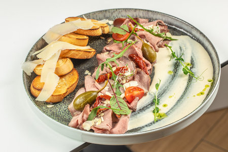 Pastrami slices, dried beef meat with vegetables and a delicate sauce,の写真素材