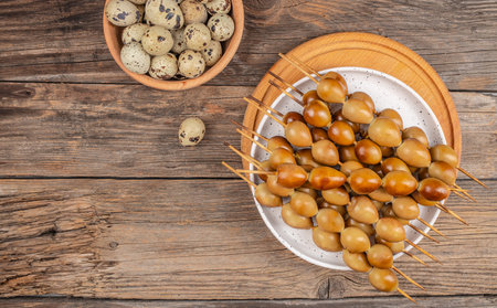 smoked eggs quail on a skewer organic eggs from local farm, top view. copy space.の写真素材