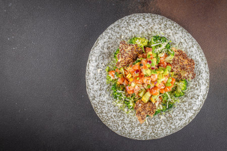 Delicious avocado and raw salmon salad, tartare. on a dark background. top view. copy space for text.の写真素材