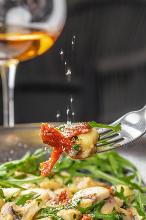 Italian Traditional potato gnocchi with smoked bacon, arugula, parmesan cheese. Top view. Copy spaceの写真素材
