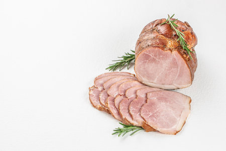 pork ham slices on a white background. Cold smoked meat with slices on a wooden board, top view.の写真素材