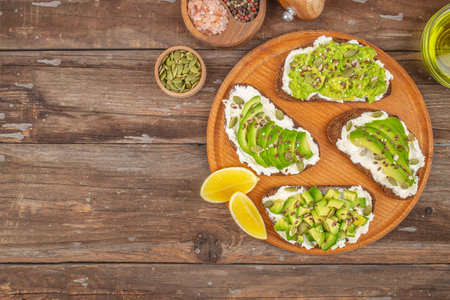 Sandwich with avocado and seeds on the wooden table, Healthy food, diet lunch concept. top view. place for text.の写真素材